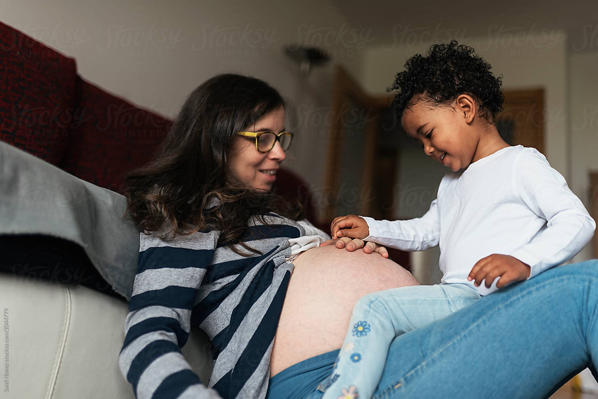Beautiful Mixed Race Girl Playing With Pregnant Mothers Belly By Stocksy Contributor Santi 