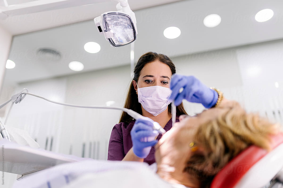 Dentists during a dental intervention with a patient.