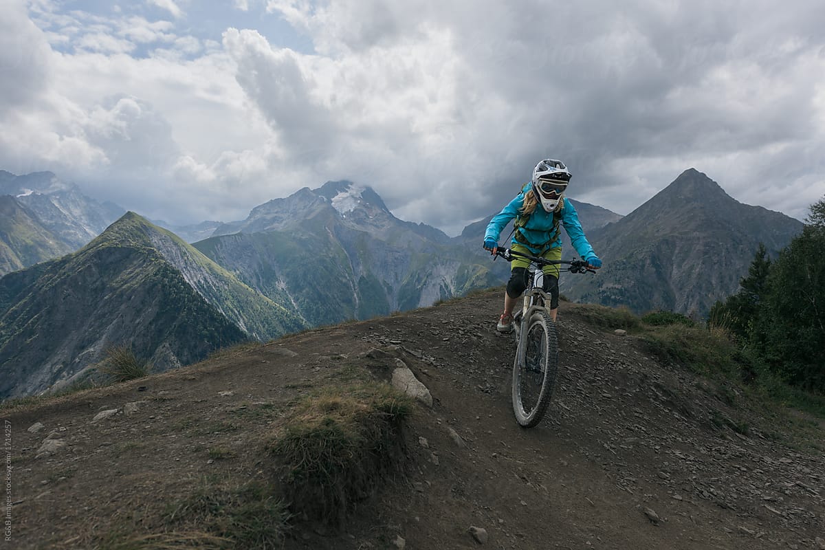 Woman riding mountain bike downhill backcountry route
