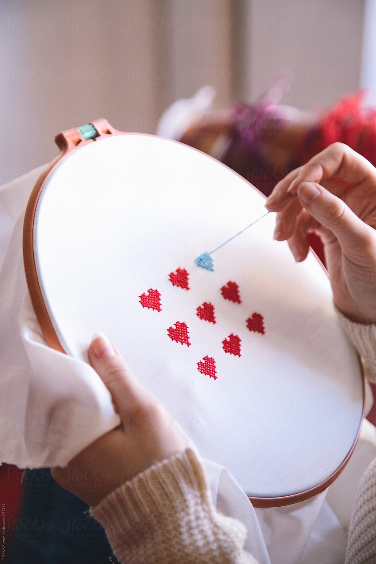 Close-up of woman\'s hands doing embroidery.Valentine\'s day
