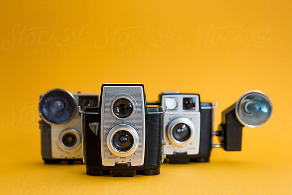 Vintage Cinema Camera And Reels Over Yellow Background by Stocksy  Contributor Kkgas - Stocksy
