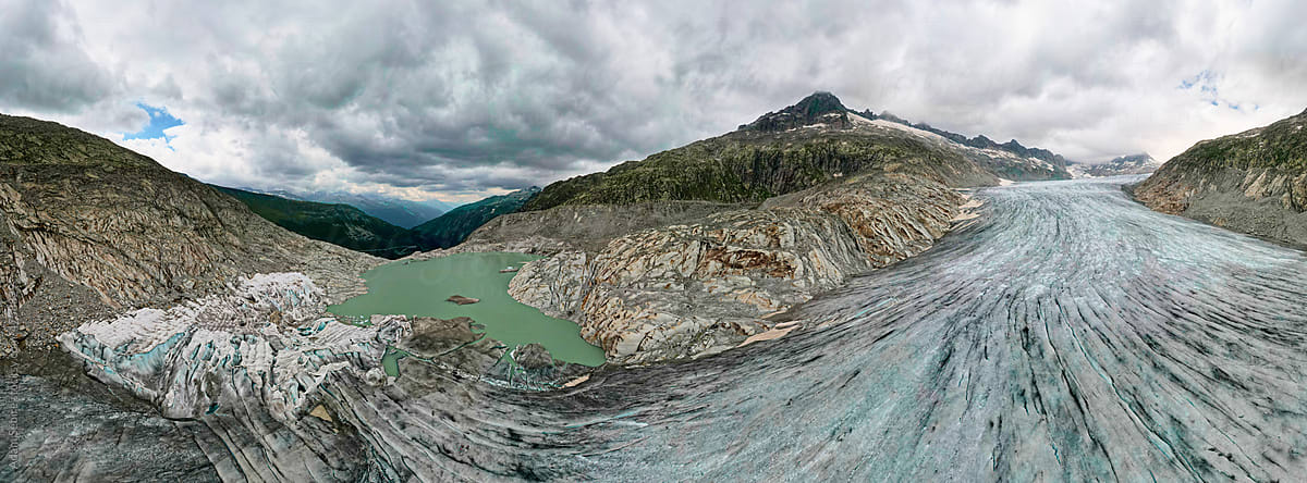 Global warming thawing glacier in Alps, aerial panorama