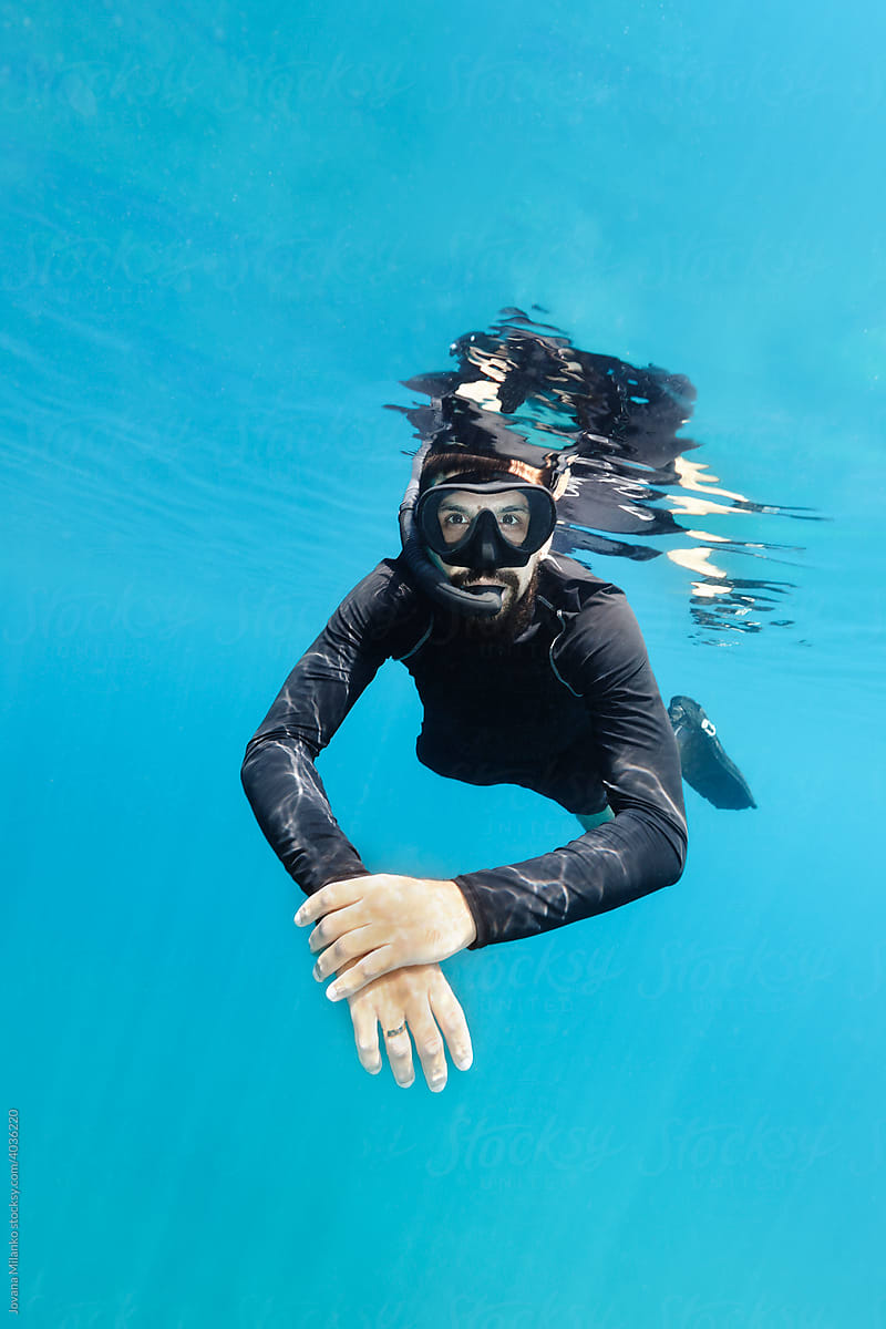 Man Snorkeling in the Blue Sea