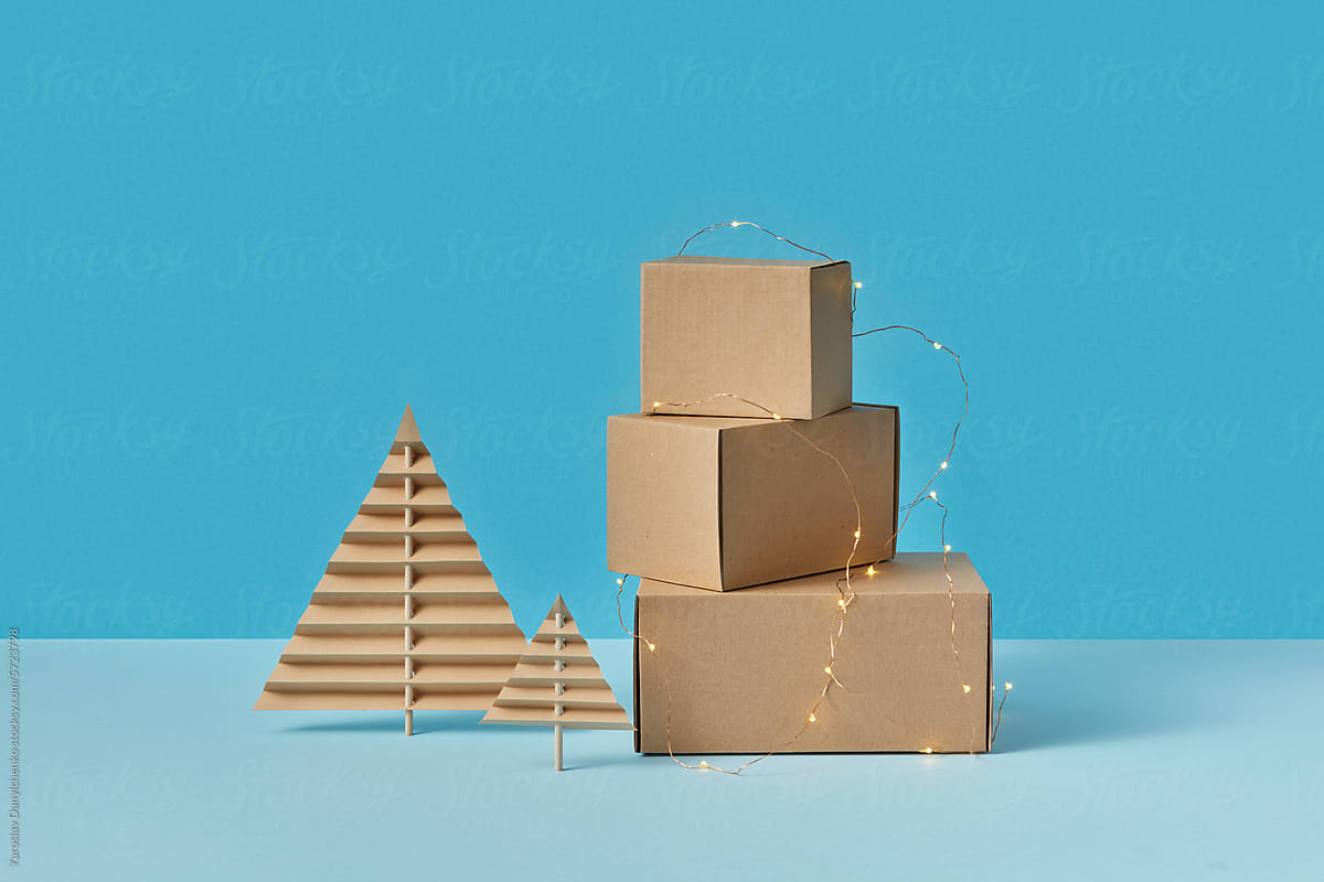 Paper Christmas trees and cardboard boxes decorated with garlands