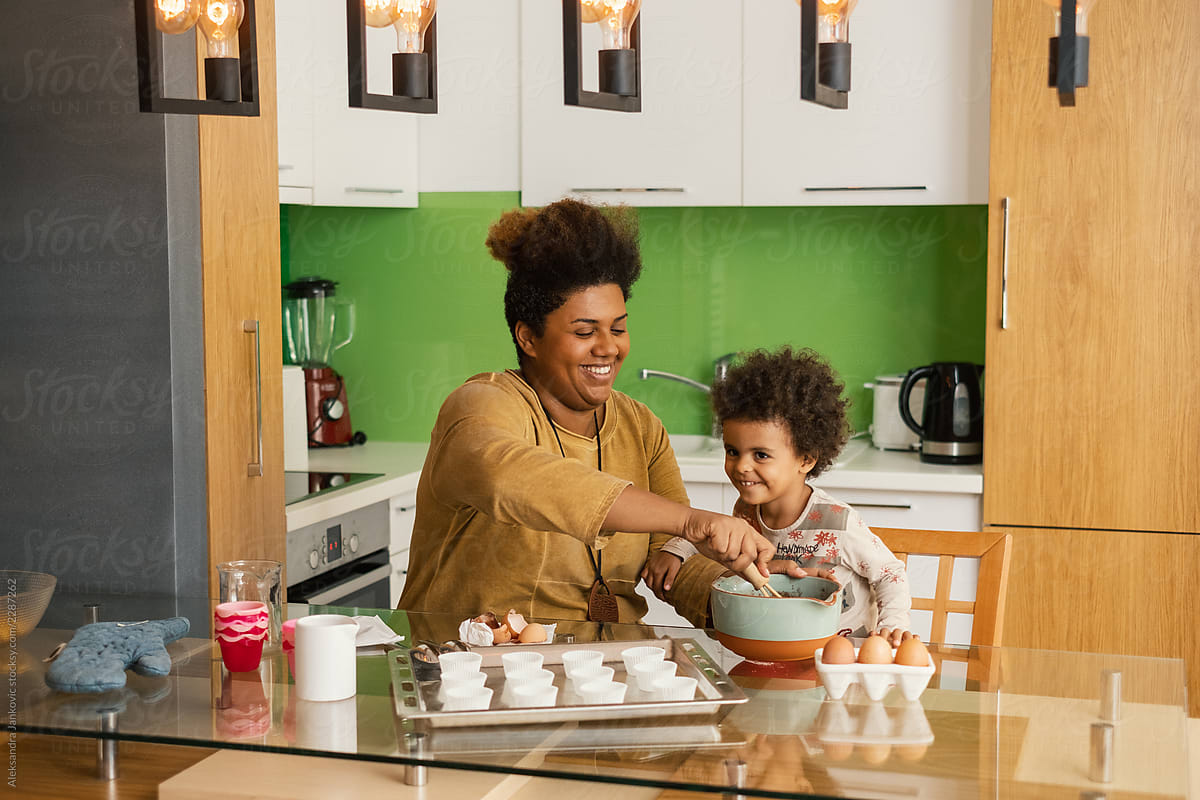 Smiling Black Mother And Daughter Baking Together
