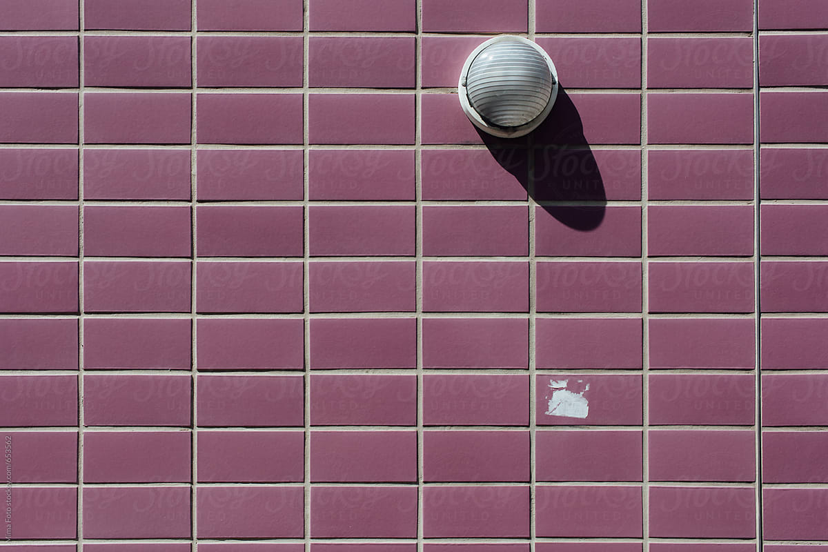 Purple tile wall with round lamp