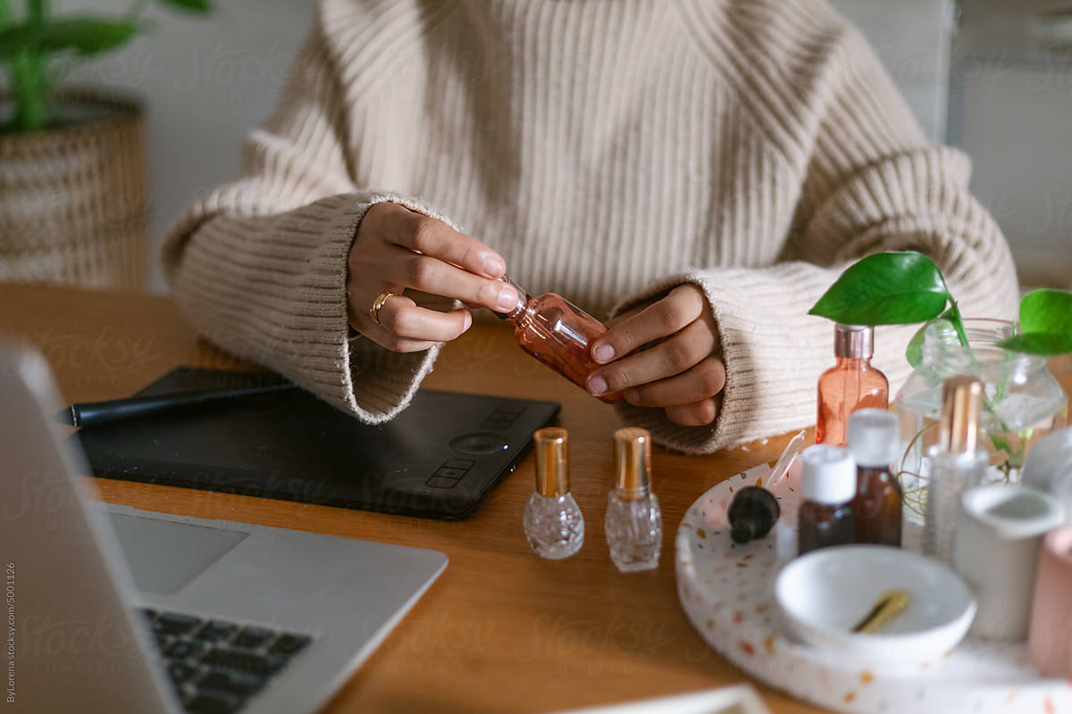 Perfumer creating homemade scents at desk