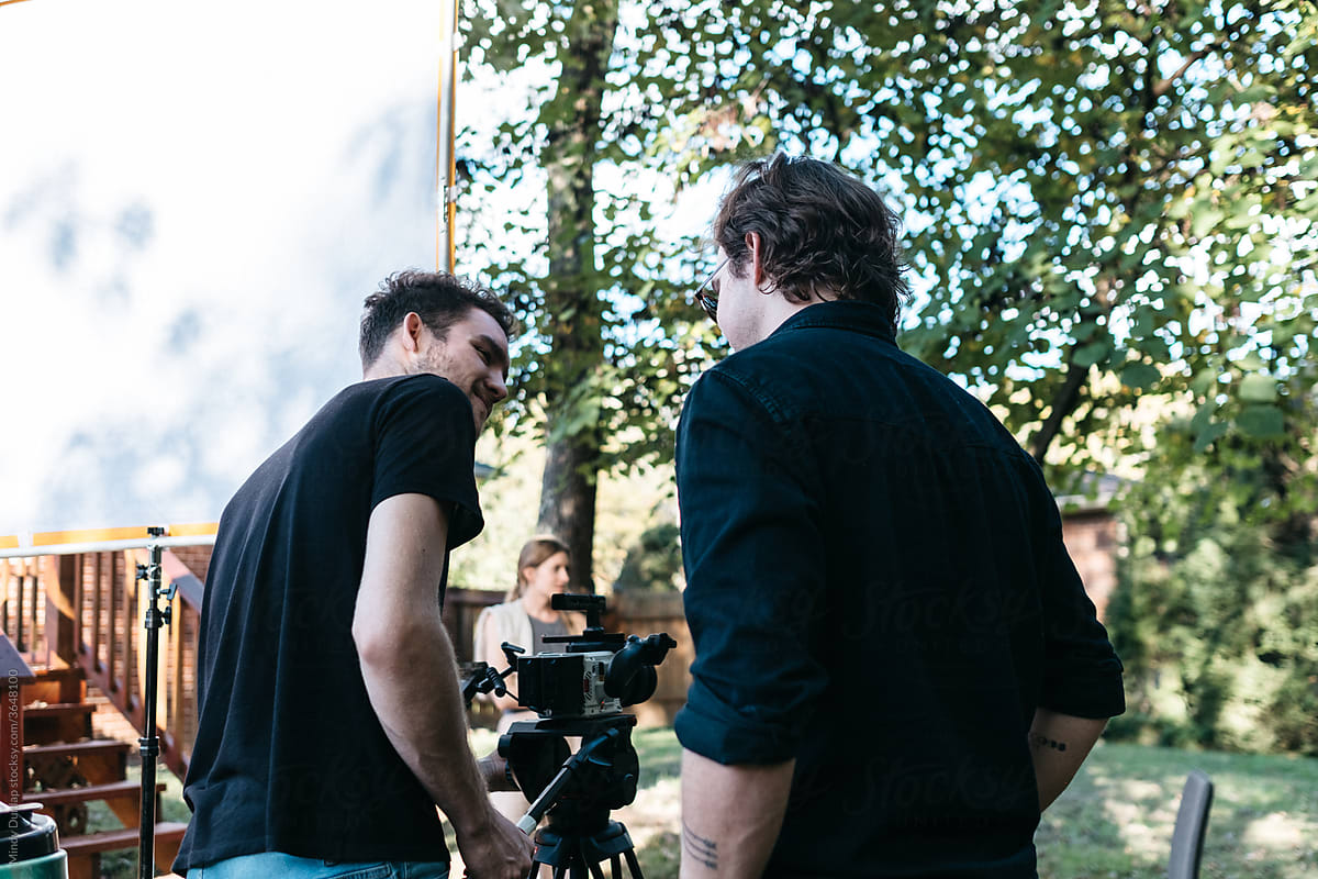 Camera operator and director filming outdoors
