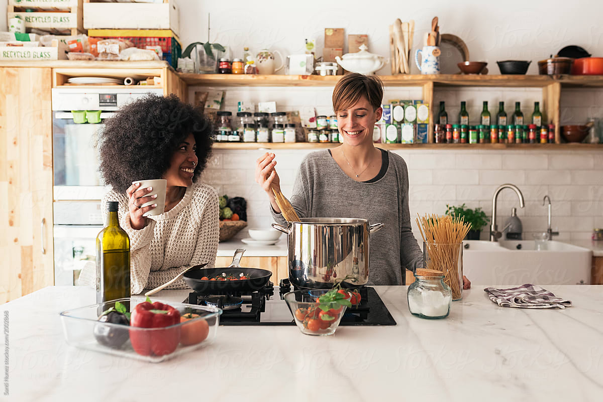 Two Beautiful Girls Cooking In Them Home Del Colaborador De Stocksy Santi Nuñez Stocksy 