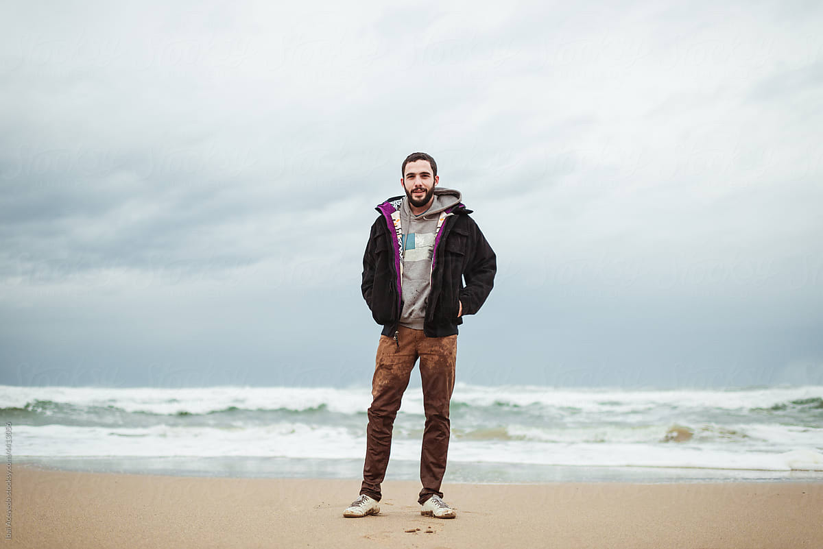 Standing man with wet pants on the beach