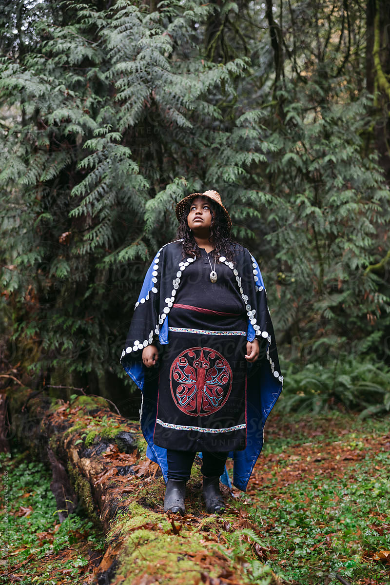 Serious portrait of young woman in indigenous regalia.
