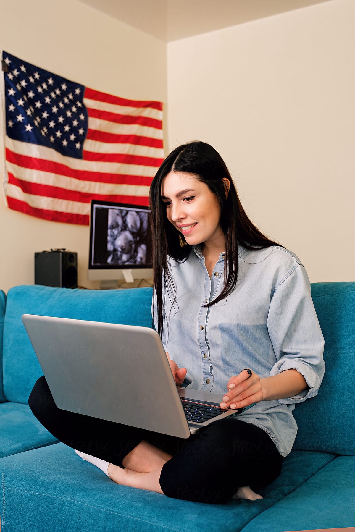 Woman in living room with notebook. Fourth of July