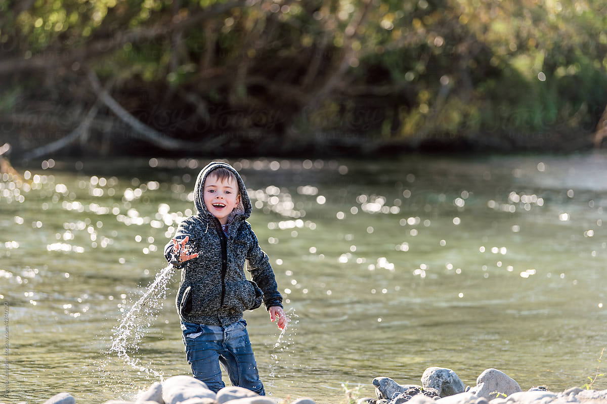 Small child having fun in a river