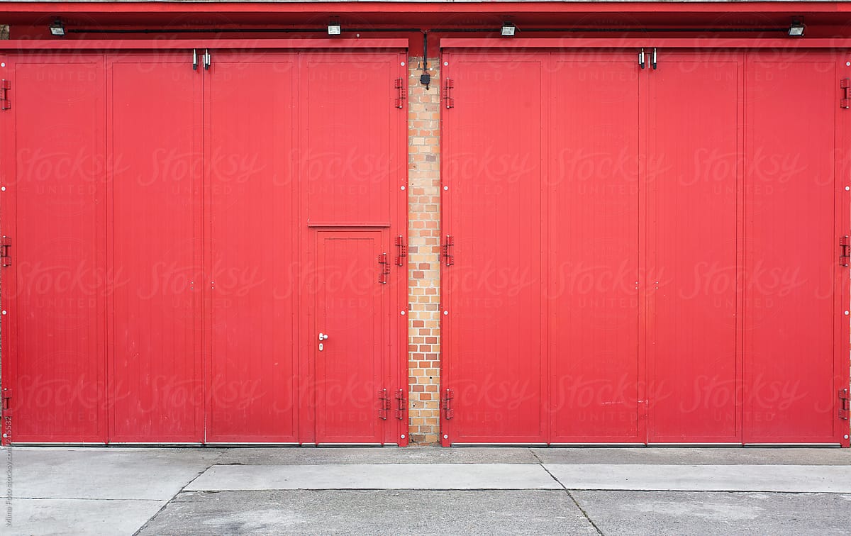 Red garage doors and small door