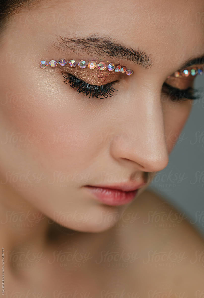 Beauty portrait with gems on eye lid