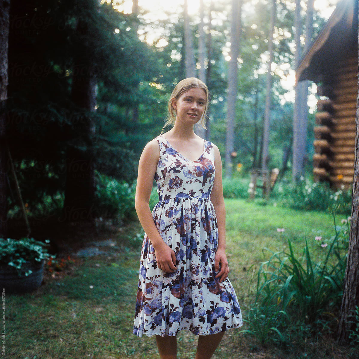Smiling teen by a cabin