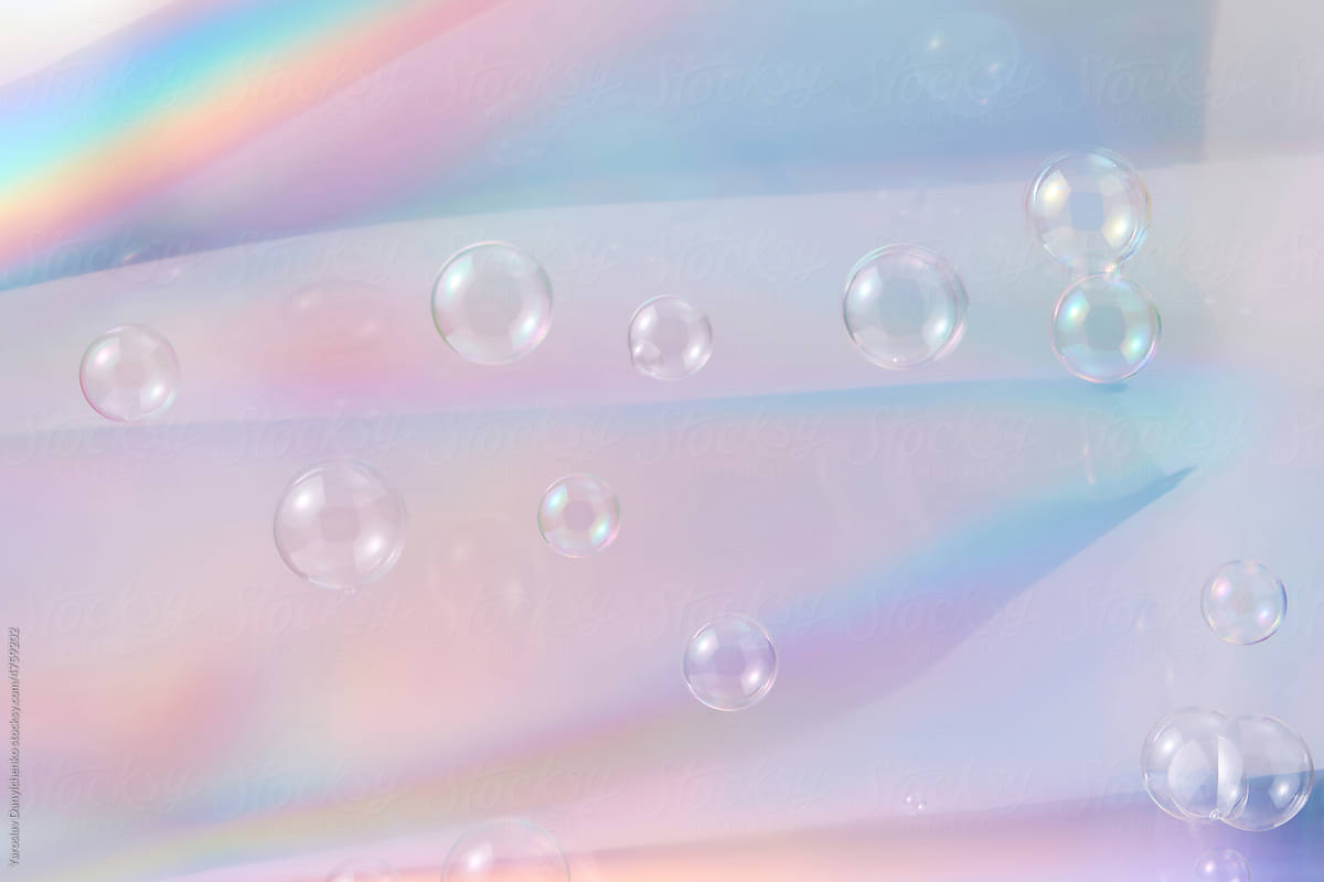 Soap bubbles on shiny holographic backdrop