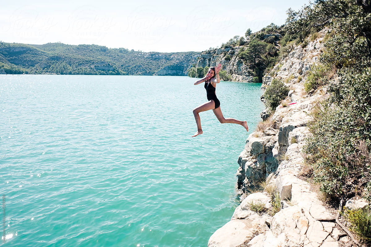 Teen Girl Jumping Off Cliff In A Lake In Provence By Stocksy Contributor Léa Jones Stocksy