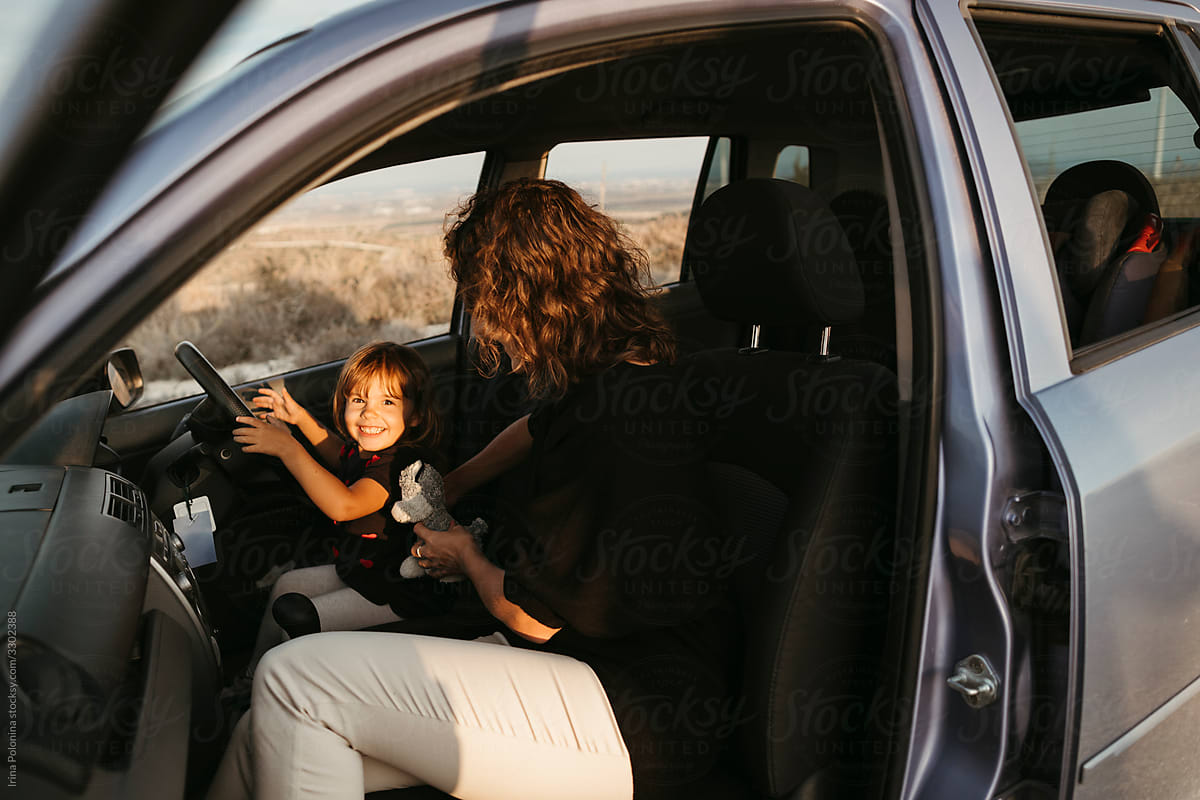 A young family with  little daughter traveling by car.