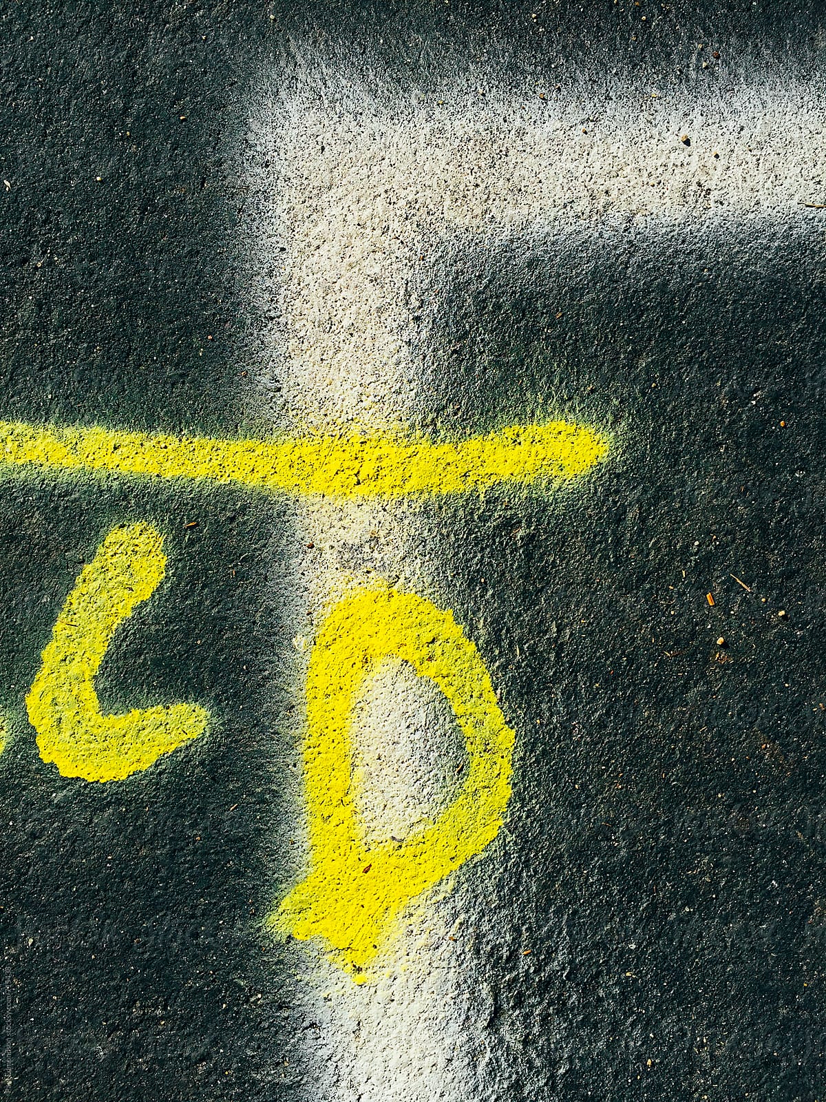 Painted lettering and lines on urban street, close up