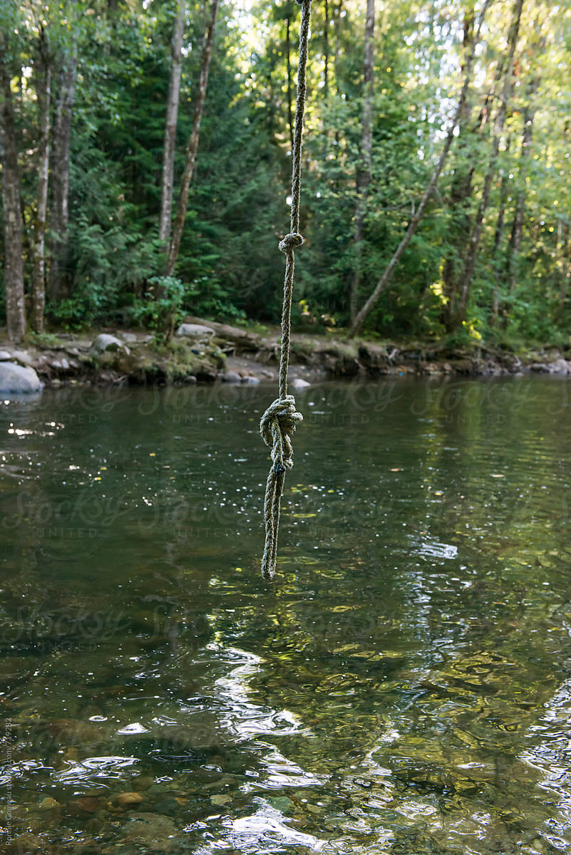 Rope Swing Over River by Stocksy Contributor Ronnie Comeau