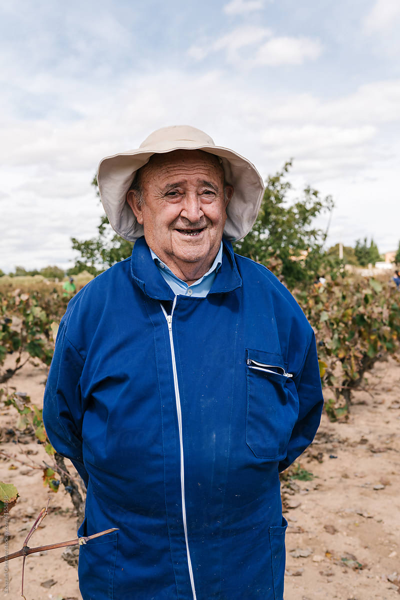 Cheerful senior farmer in vineyard