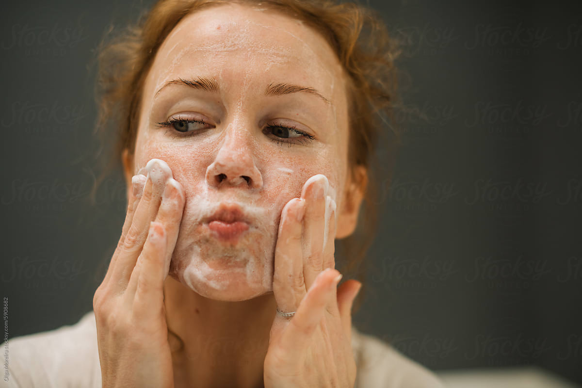 Woman doing soapy facial massage