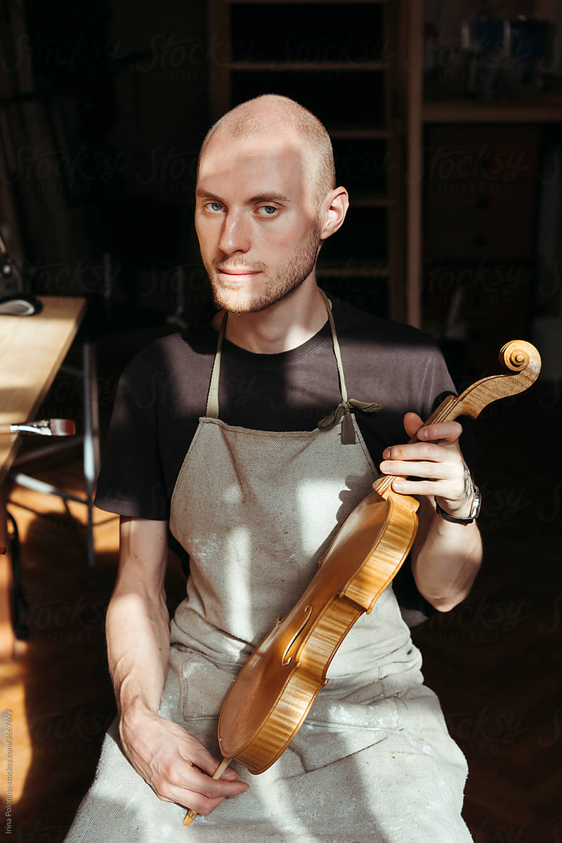 A violin artisan in his workshop.