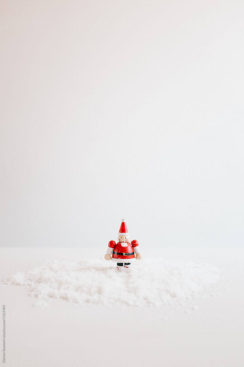 Small Santa standing in snow