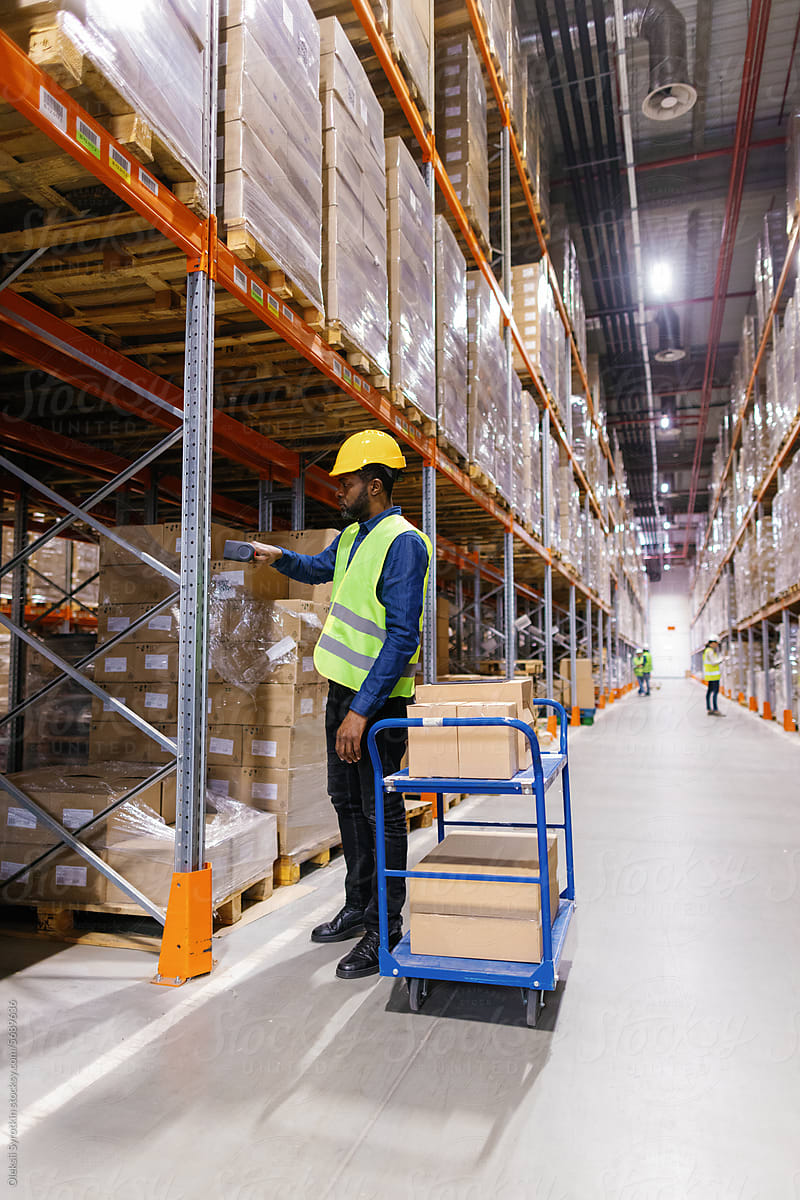 Logistic worker scanning boxes with goods