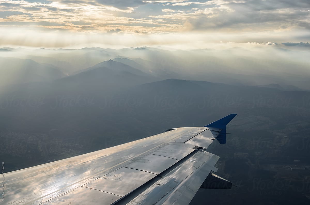 Airplane wing above mountains