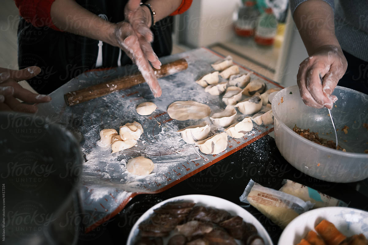 Chinese Women Make Dumplings At Home During Chinese New Year.