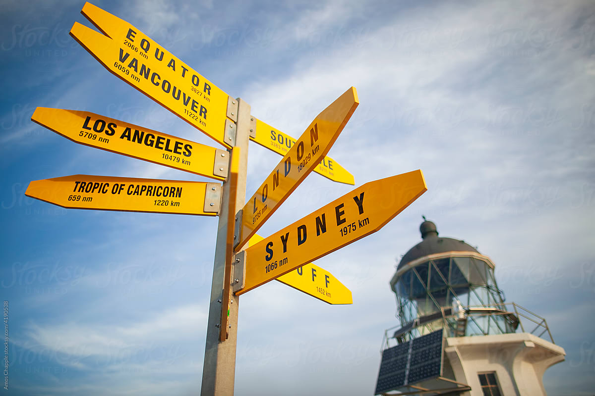 A signpost in front of the Cape Reinga Lighthouse.