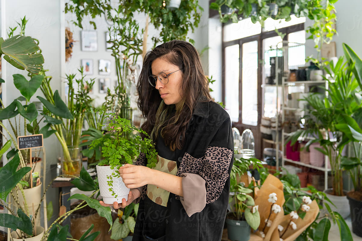 Young Woman Working In A Plants Store.