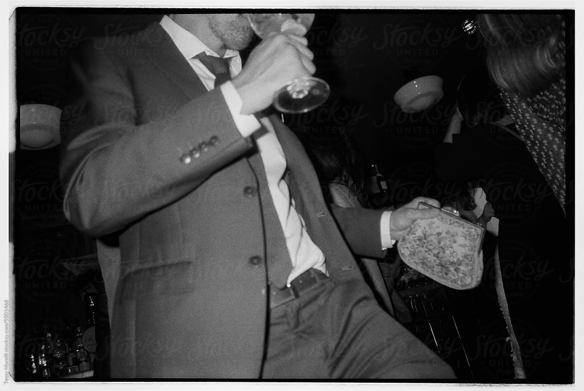 Bw dancing anonymous man with a purse
