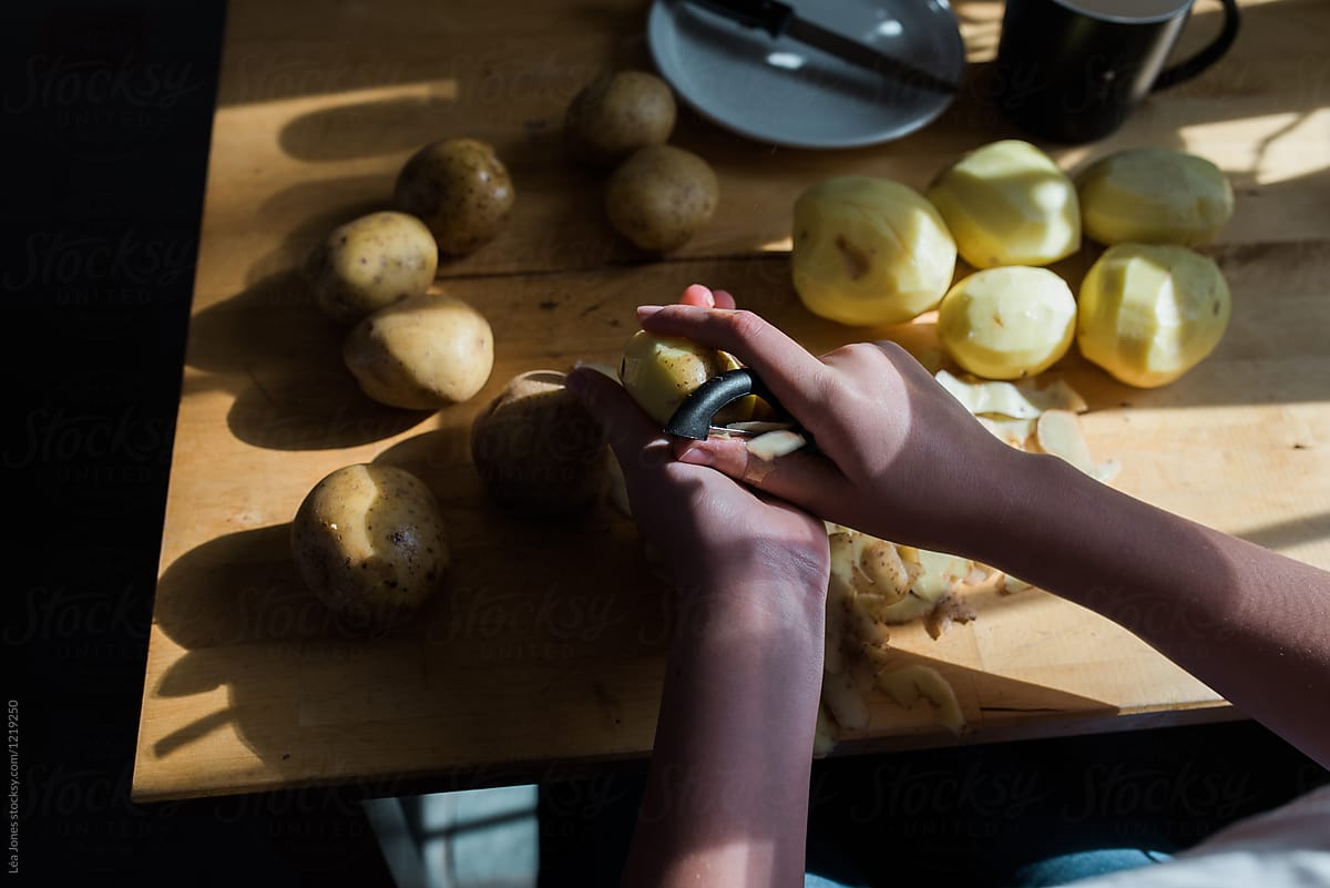 teen peeling potatoes