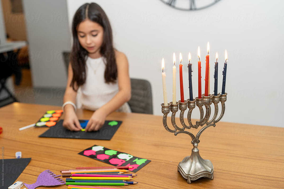 Girl Crafting Hanukkah Card. Sticker Art in Cozy Home Ambiance.