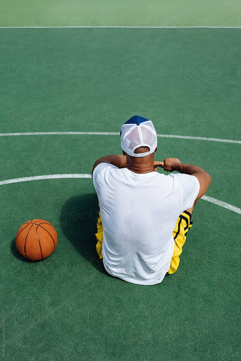 Anonymous fit black guy on a basketball court