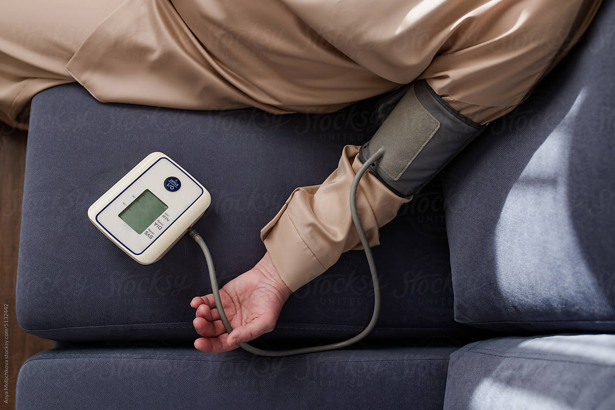 Senior Woman Measures Blood Pressure At Home