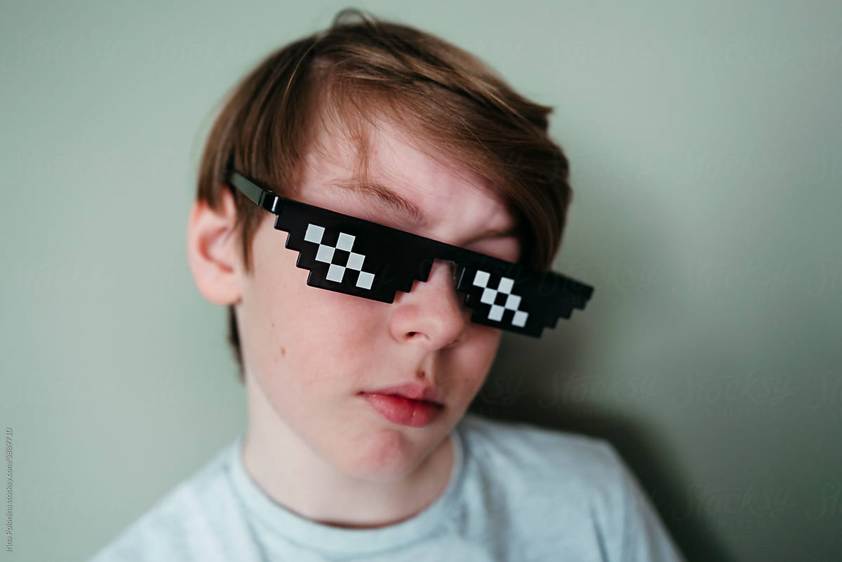 Whimsical boy in pixel sunglasses.