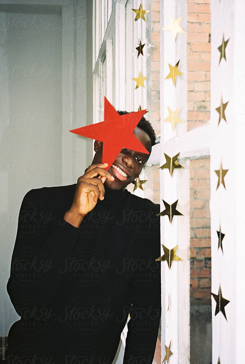 User-generated content happy man with red star near window
