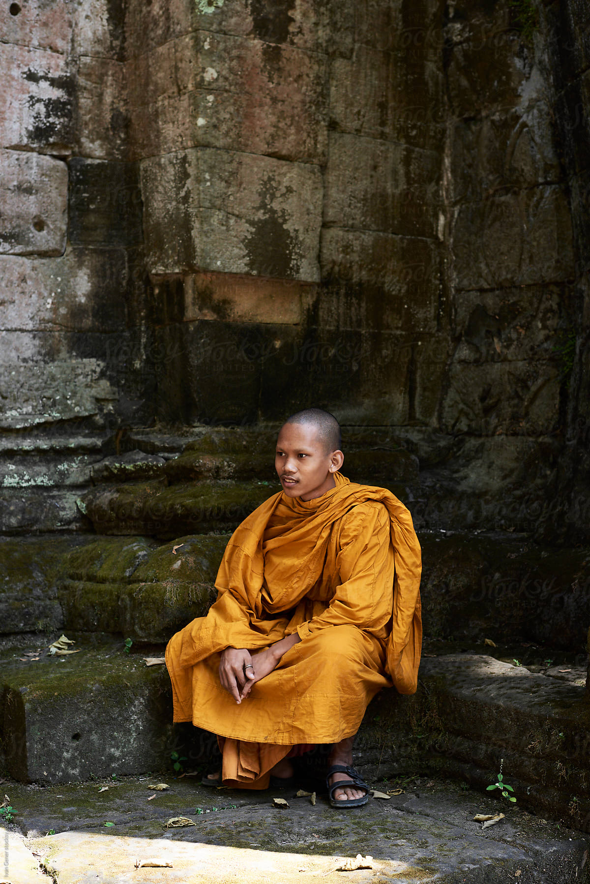 Monk in orange clothes sitting