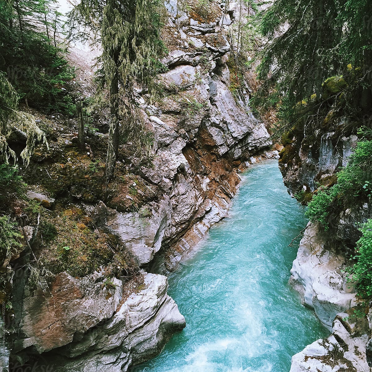 Mobile phone capture of a blue river cutting through a canyon