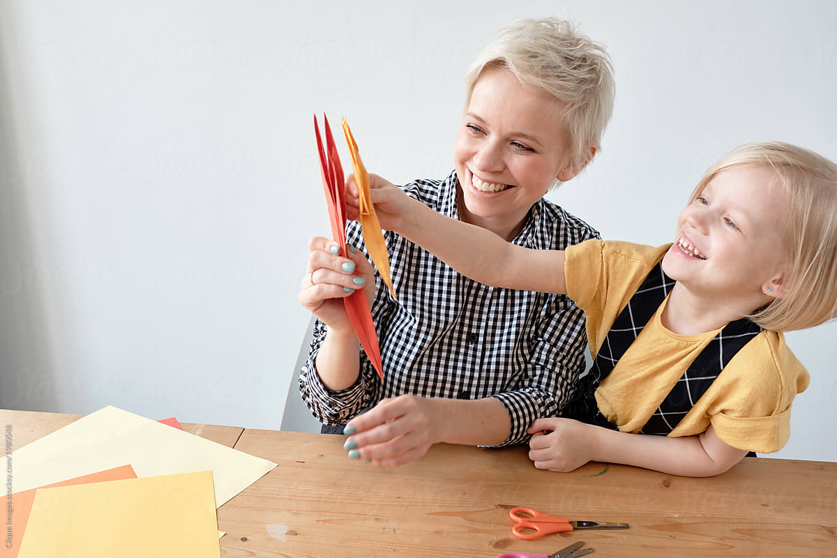 Mom And Daughter Playing With Origami By Stocksy Contributor Clique