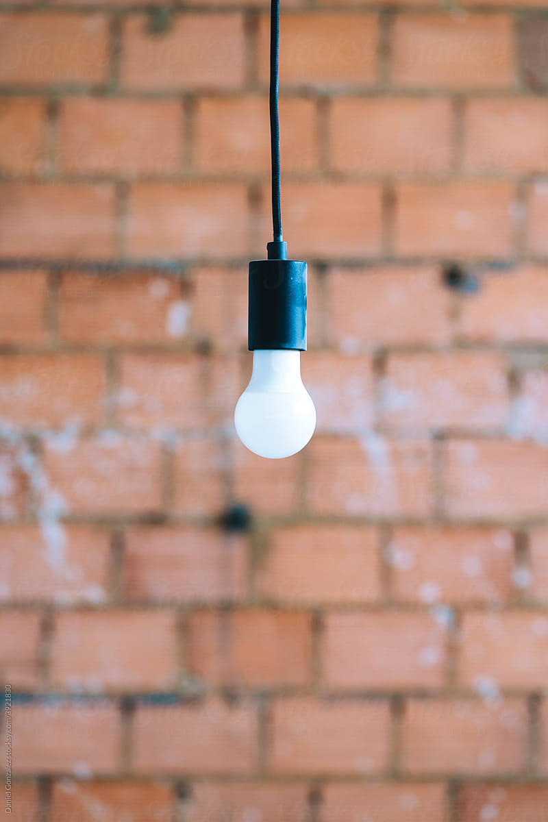 A light bulb with brick background