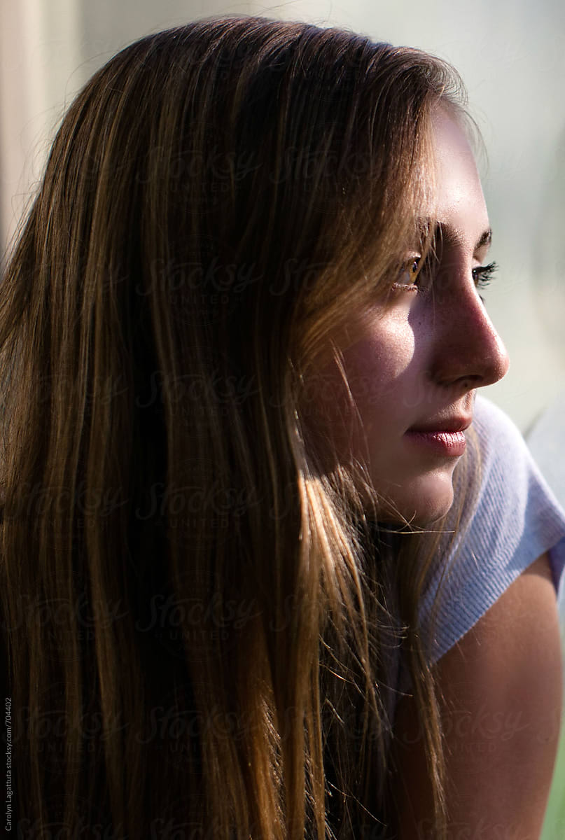 Profile Of A Beautiful Teenage Girl With Long Hair By Stocksy