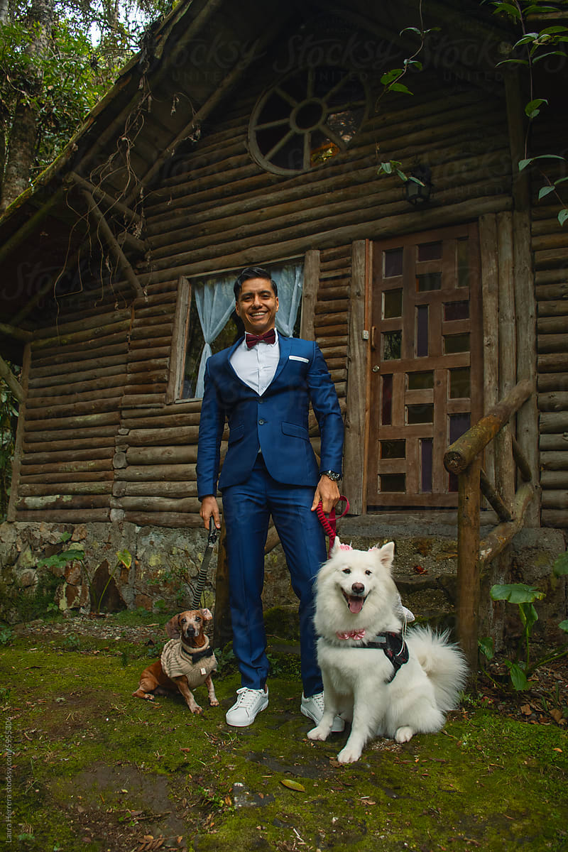 Groom Walking with Samoyed and Dachshund Ring Bearers by Cabin