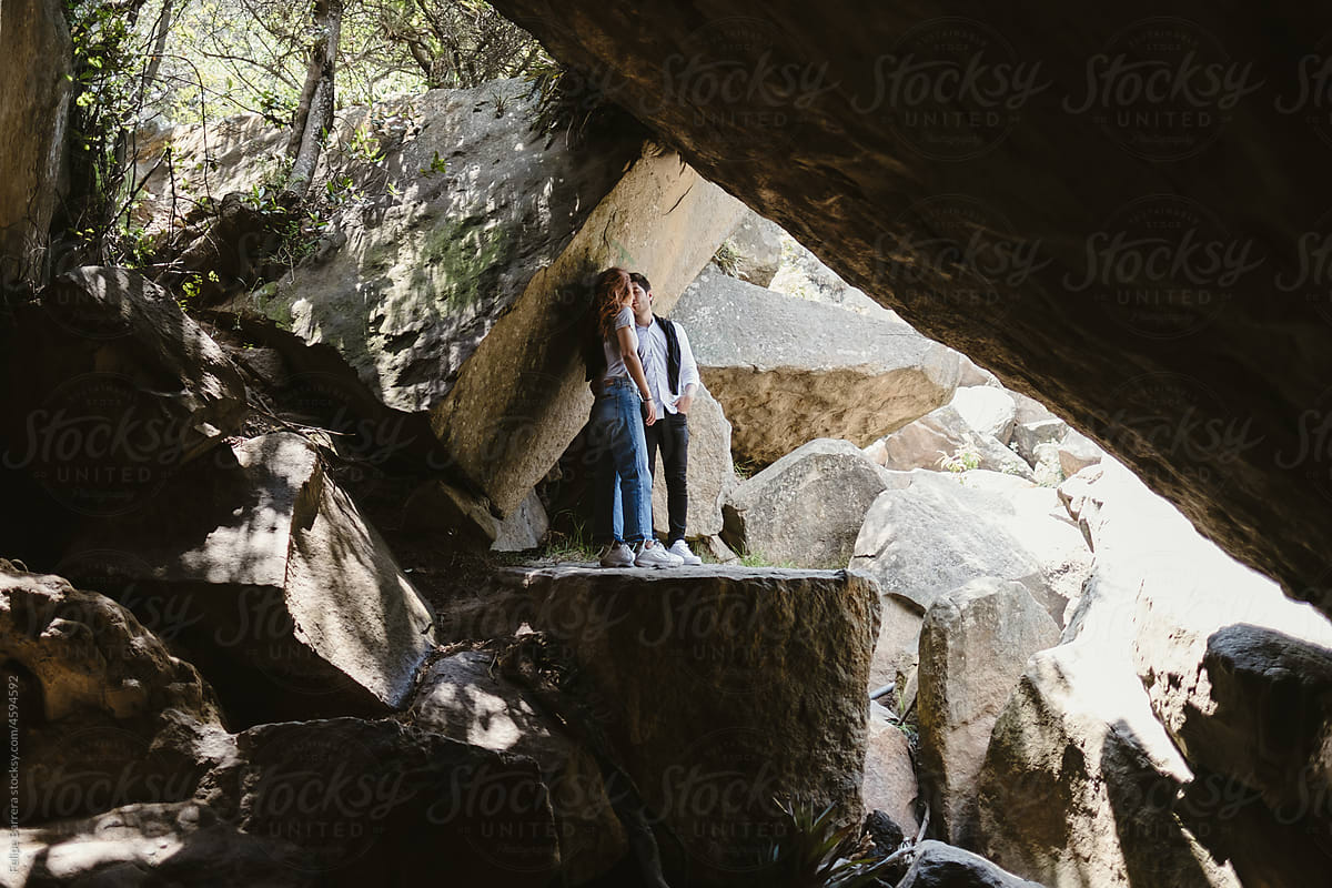 couple standing on a cave rock