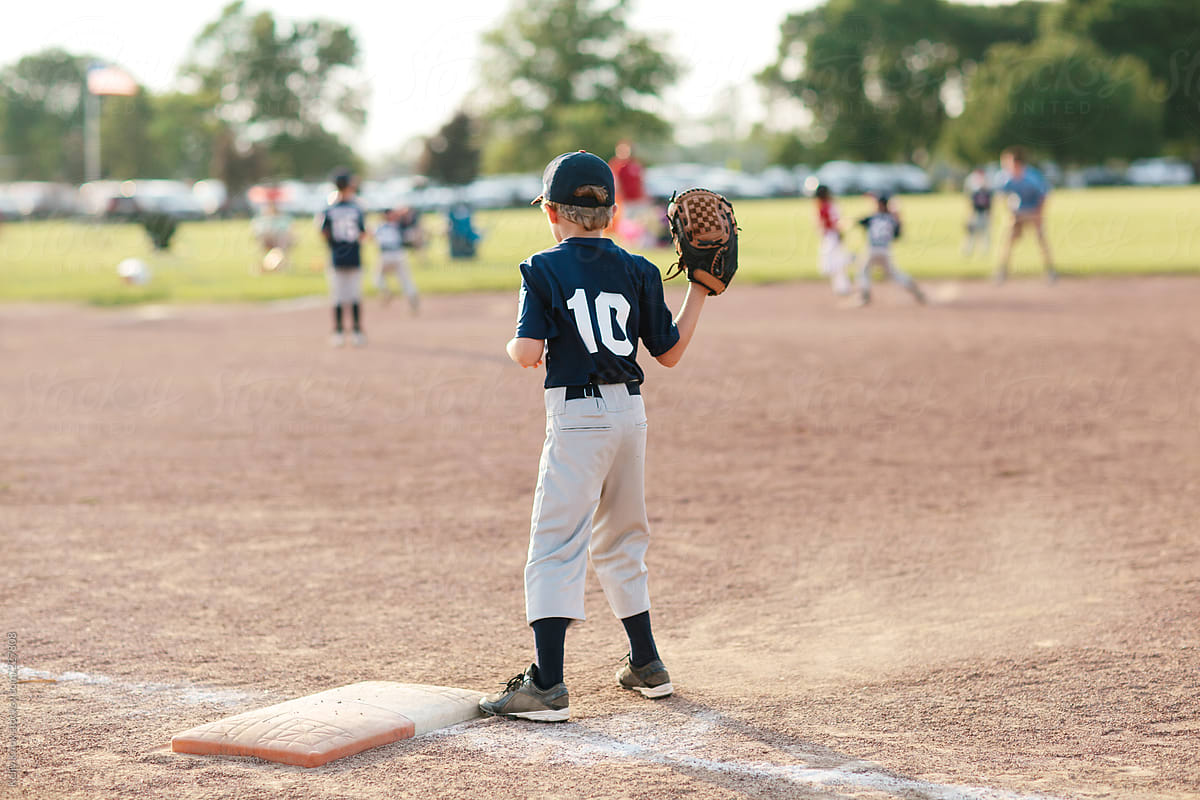 baseball player stands ready with glove on first base