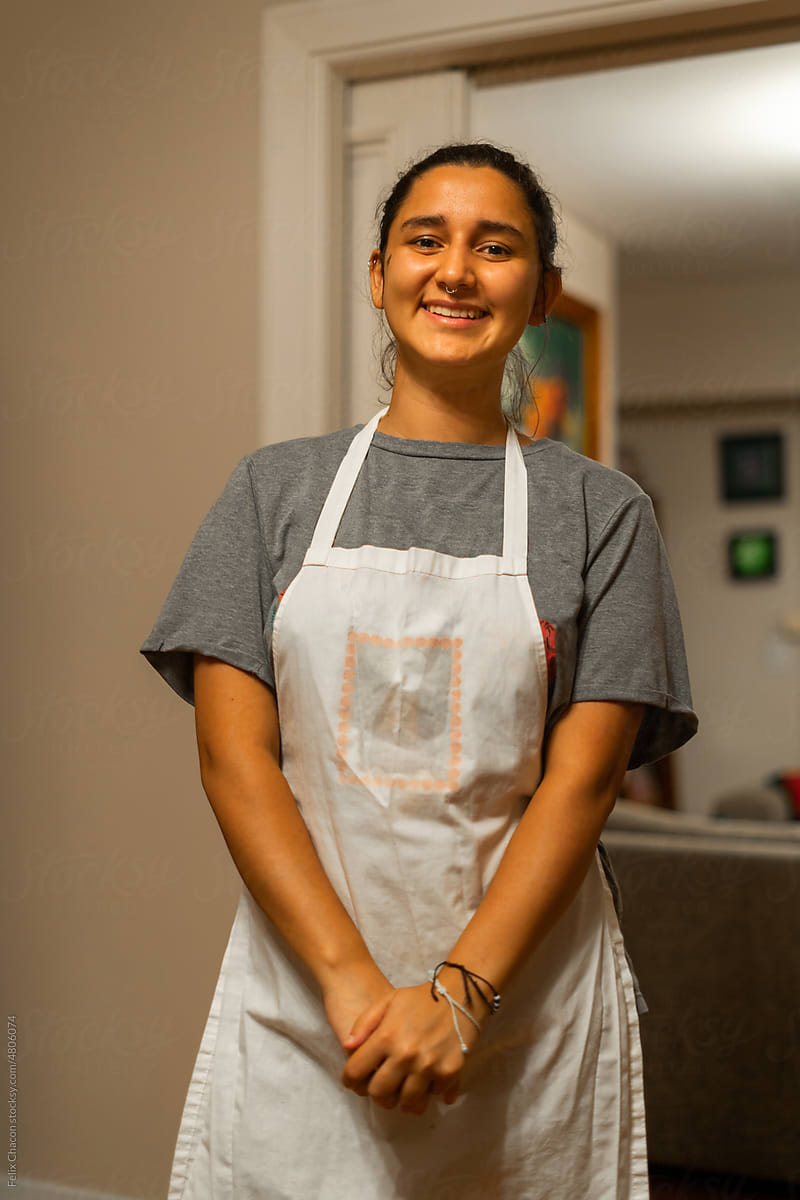 Latina woman with apron at home